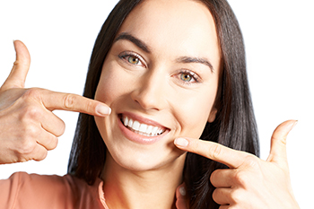 woman pointing at her smile