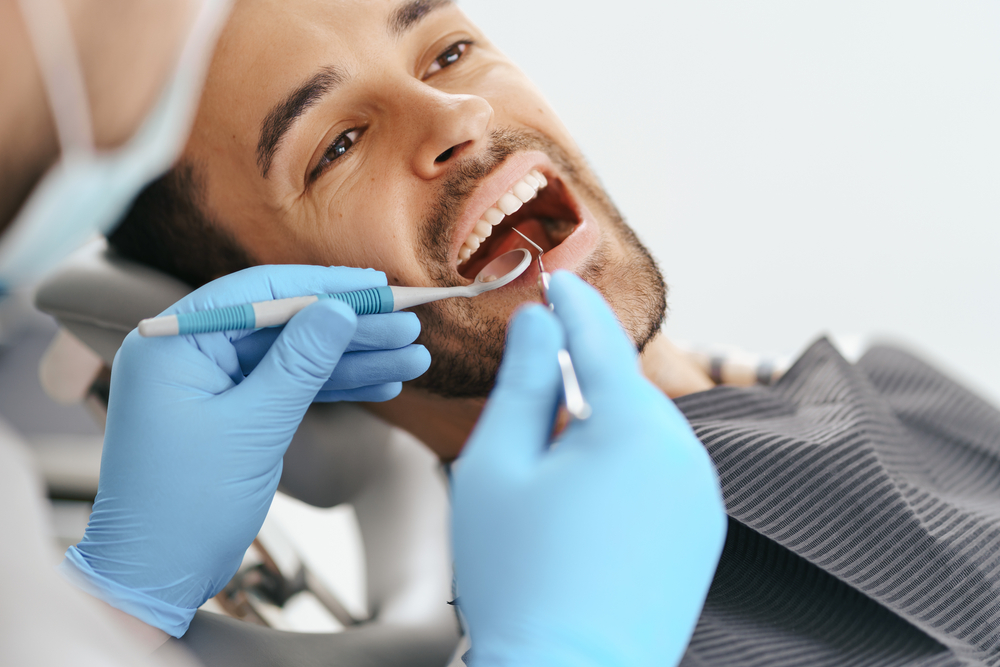 man having teeth examined