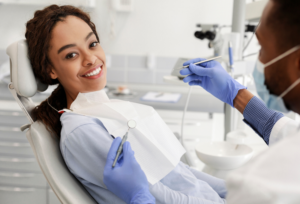 smiling woman in dental chair receiving treatment