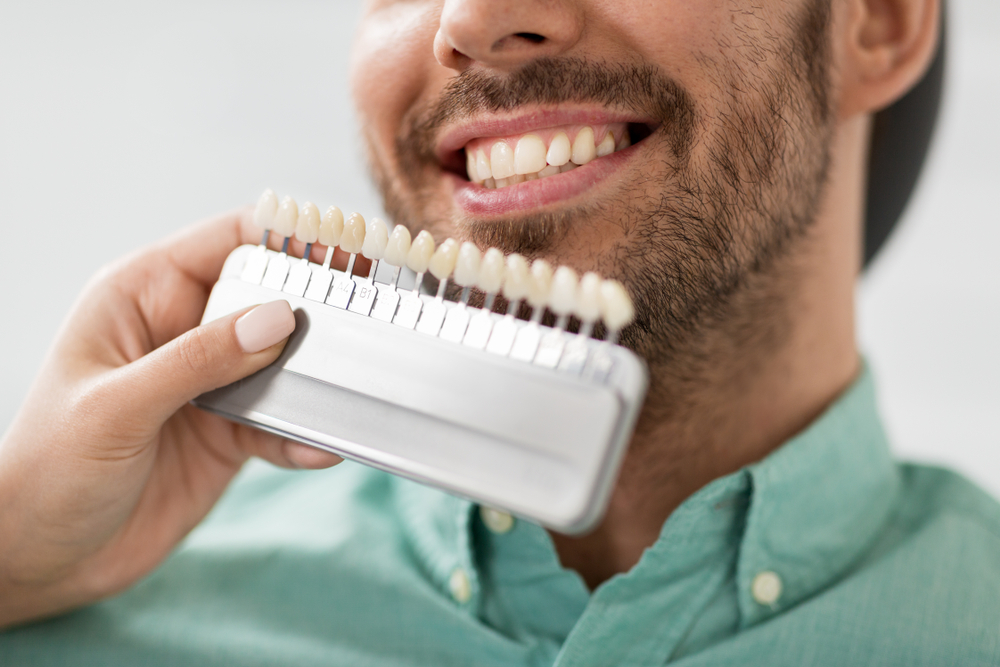 dentist color matching patient's teeth