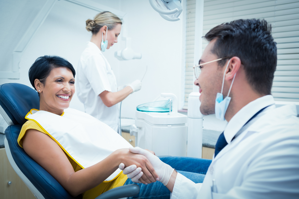 patient shaking dentist's hand