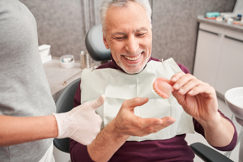 patient holding denture